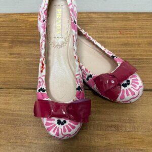 Prada pink floral ballet flats with bow detail.
